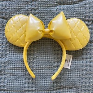 Plush yellow Minnie Mouse ear headband. Purchased on ShopDisney 2023.